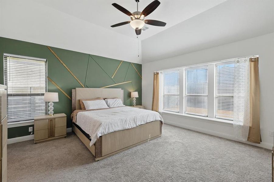 The Primary Bedroom is a quiet and soothing retreat - large & filled with natural light from a multitude of windows, not to mention it offers tasteful artistic accents.