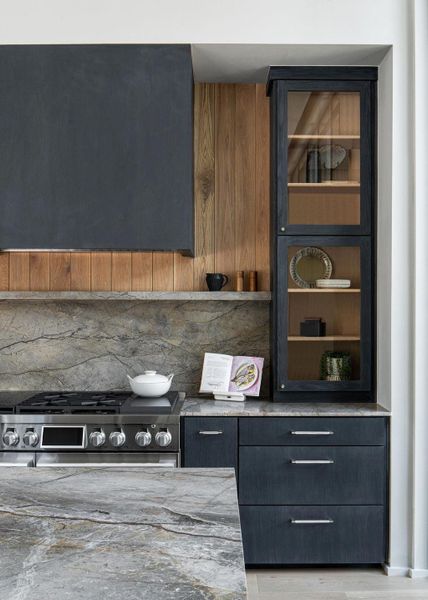 It's all in the details with custom white oak cabinets, venthood and surround elevated with  honed marble backsplash and countertops.