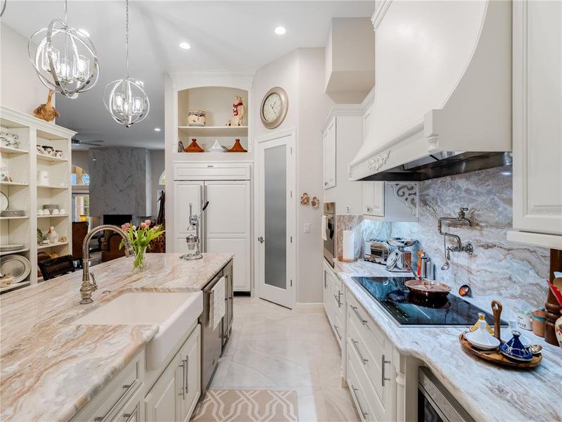 Kitchen with Sub Zero Refrigator, Pantry, and cooktop with pot filler