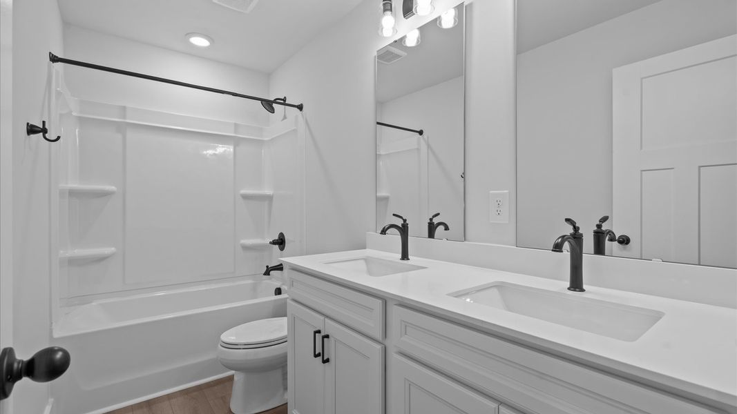 Highly skilled design seen in this polished and practical full bathroom