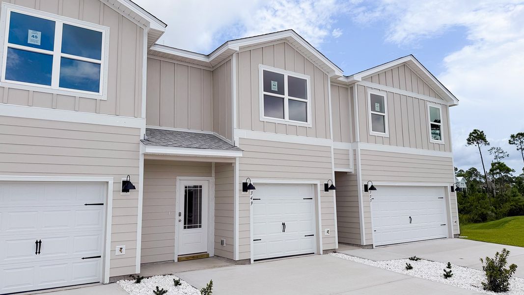 Front exterior of a new home in WindMark Beach, Port Saint Joe, FL, highlighting curb appeal (Image 19).