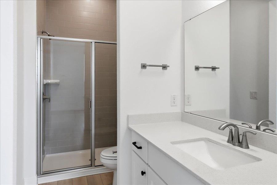 A well-appointed bathroom features a spacious shower with sleek glass doors and a pristine vanity with ample counter space. A well-appointed bathroom features a spacious shower with sleek glass doors and a pristine vanity with ample counter space.