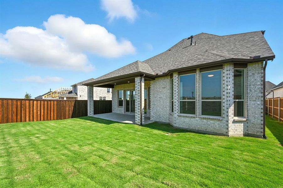 Rear view of property with brick siding, a patio, a fenced backyard, and roof with shingles Rear view of property with brick siding, a patio, a fenced backyard, and roof with shingles