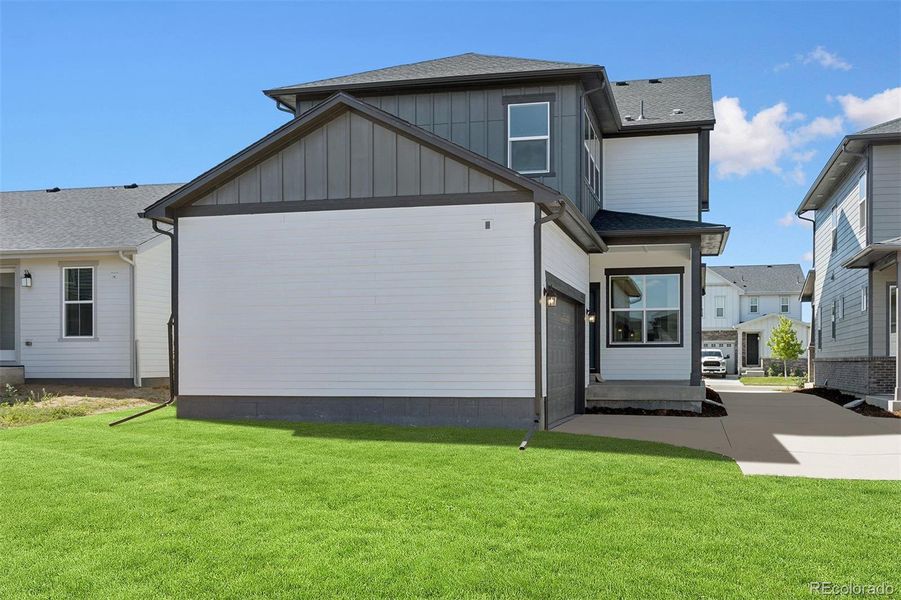 Front exterior of a new home in Painted Prairie Cottage, Aurora, CO, highlighting curb appeal (Image 24).