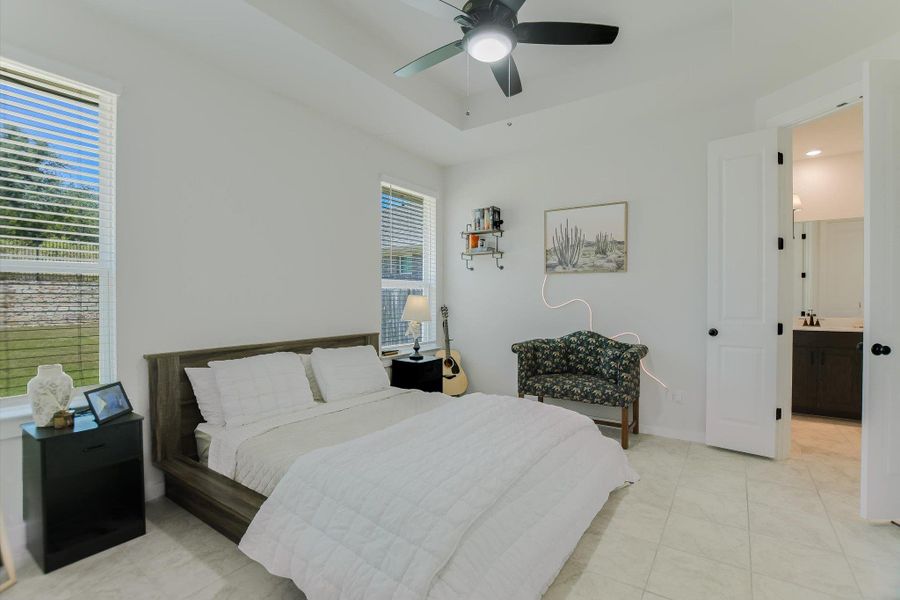 A tranquil bedroom provides comfort and convenience, with an en-suite bathroom just beyond a crisp white door. A tranquil bedroom provides comfort and convenience, with an en-suite bathroom just beyond a crisp white door.