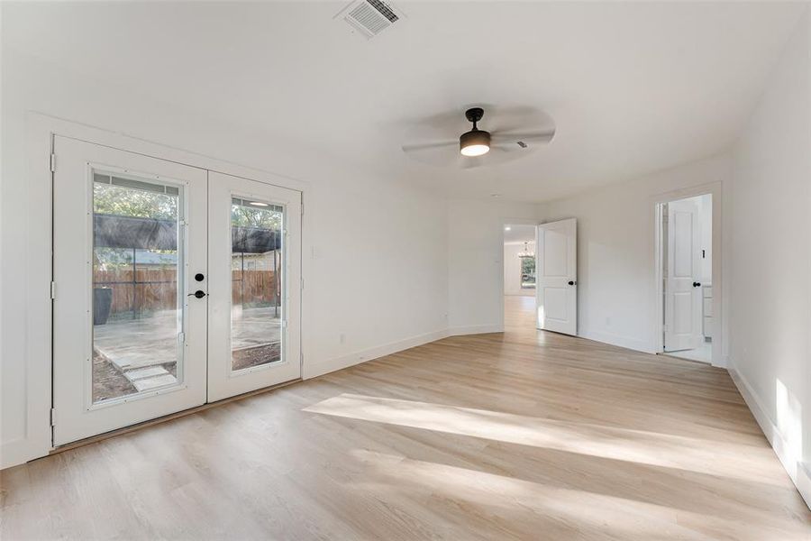 Spare room with light hardwood / wood-style flooring, french doors, and ceiling fan