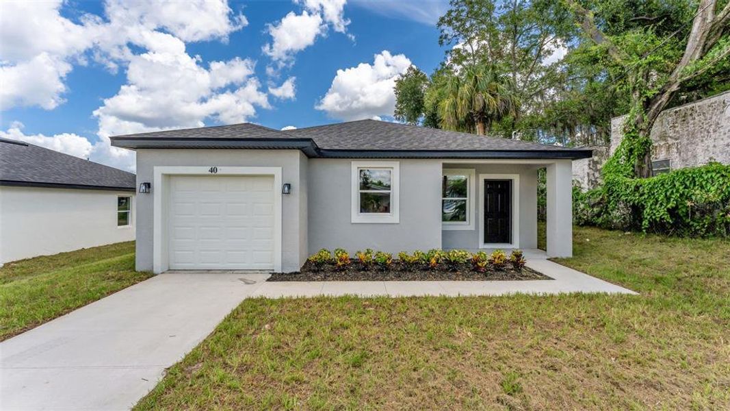 Front exterior of a new home in , Haines City, FL, highlighting curb appeal (Image 1). Front exterior of a new home in , Haines City, FL, highlighting curb appeal (Image 1).