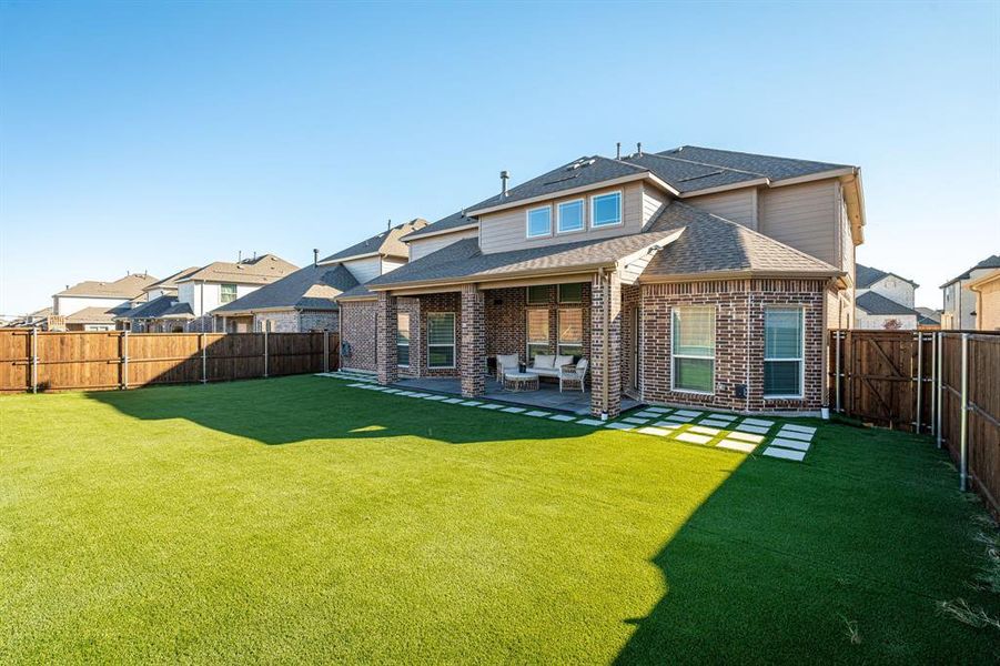 Rear view of house with outdoor lounge area, a patio area, and a lawn