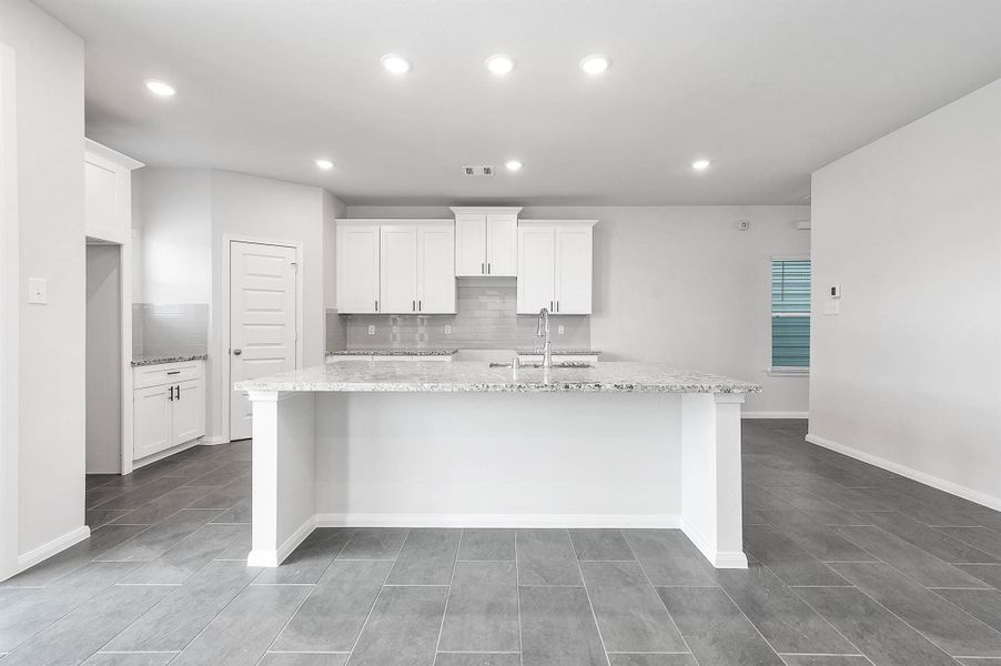 Additional view of the kitchen featuring the generous counter space, and ample cabinetry. Additional view of the kitchen featuring the generous counter space, and ample cabinetry.