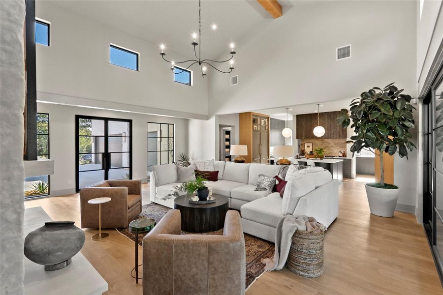 Open concept living area with large sliding glass doors and windows overlooking courtyard.