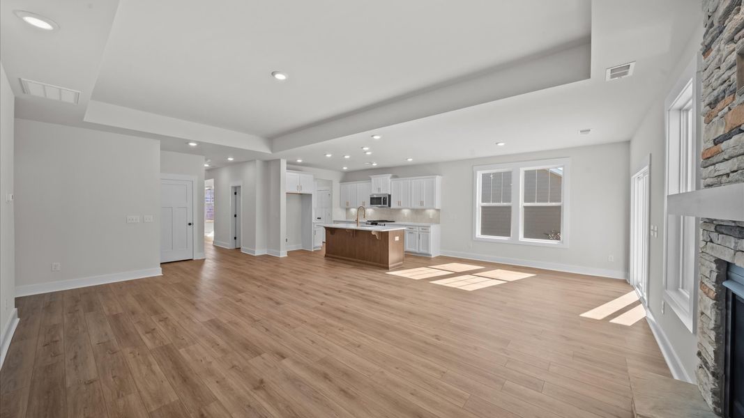 Superior design shines in this open-concept family room with tray ceiling, timeless finishes, and a modern edge Superior design shines in this open-concept family room with tray ceiling, timeless finishes, and a modern edge