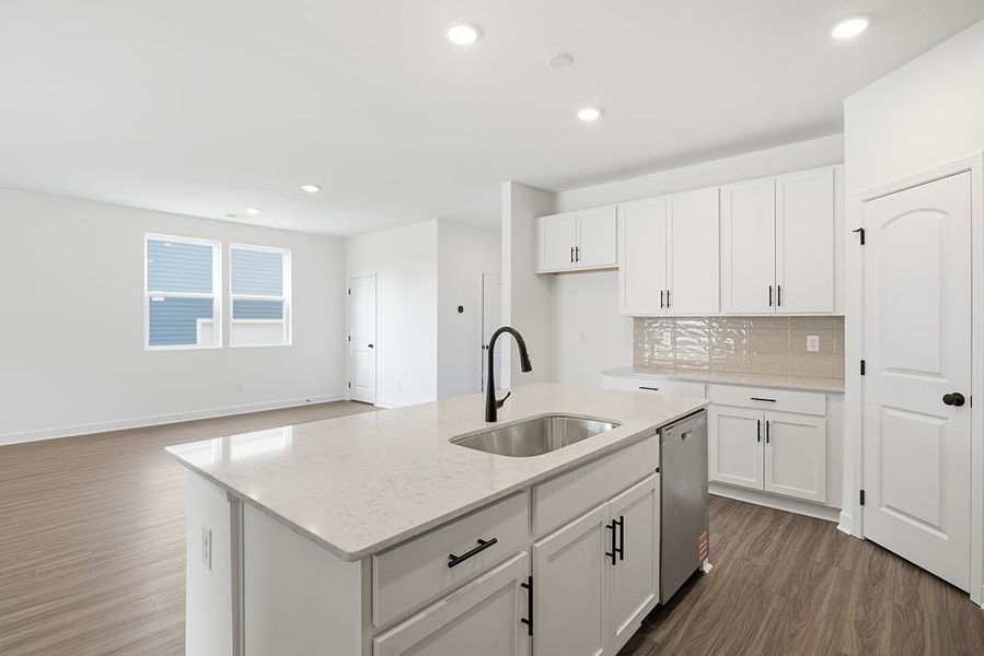 A kitchen with white cabinets.