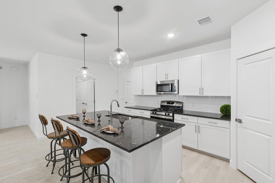 Island kitchen with white cabinets and granite counters Island kitchen with white cabinets and granite counters