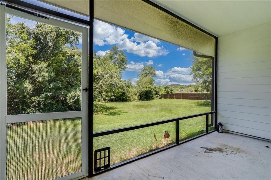 Screened patio with concrete flooring and white horizontal siding