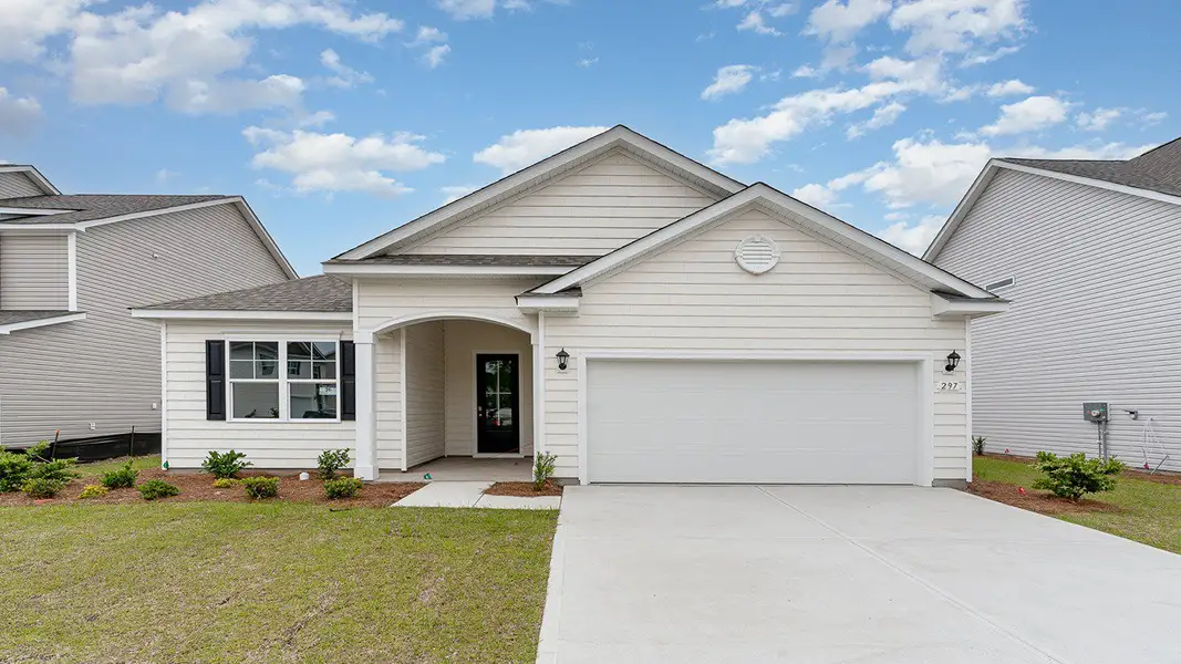 Front exterior of a new home in Brunswick Plantation, Ash, NC, highlighting curb appeal (Image 2). Front exterior of a new home in Brunswick Plantation, Ash, NC, highlighting curb appeal (Image 2).