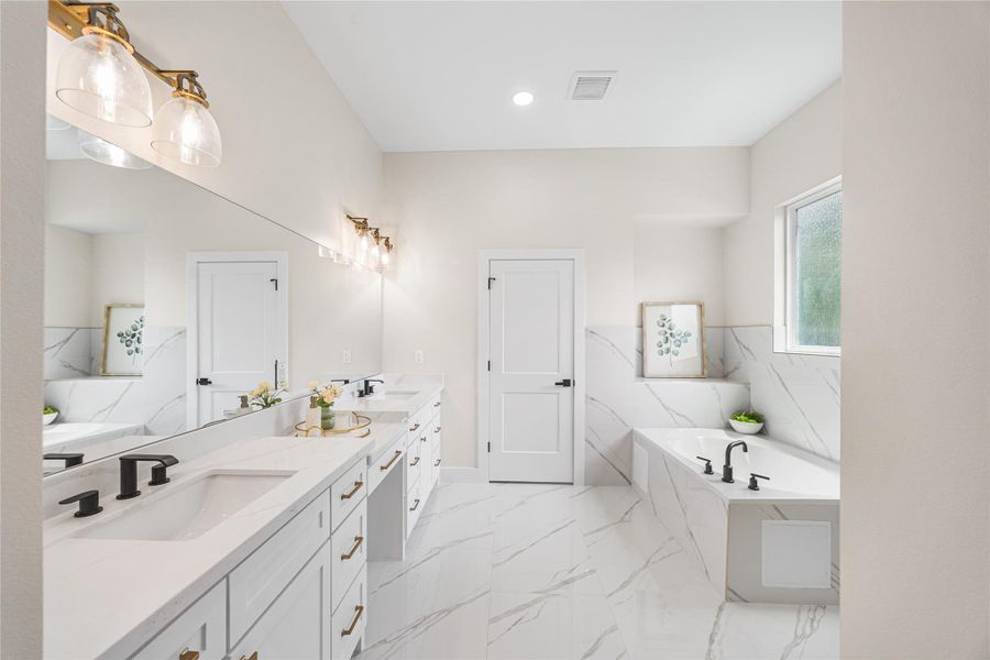 Primary En-Suite Offers Double Sinks with a Vanity, Quartz Counters, Soaking Tub that Can be Easily Upgraded to a Spa Tub with Electrical and Plumbing Completed, and Huge Walk-In Shower.