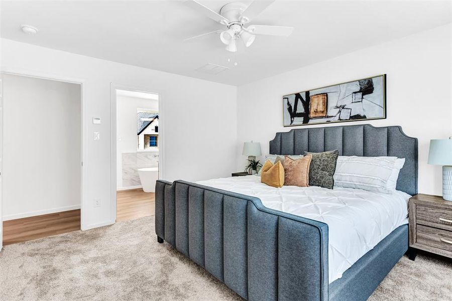 Bedroom with light wood-type flooring, ceiling fan, and connected bathroom