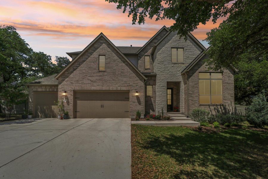 Front exterior of a new home in Wolf Ranch West Bend - 70', Georgetown, TX, highlighting curb appeal (Image 24).