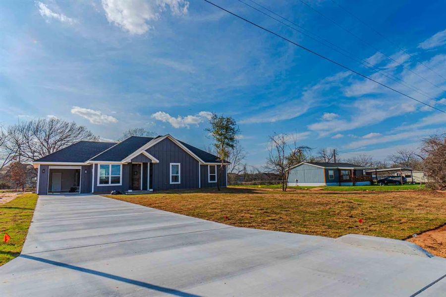 Front exterior of a new home in , Granbury, TX, highlighting curb appeal (Image 2). Front exterior of a new home in , Granbury, TX, highlighting curb appeal (Image 2).