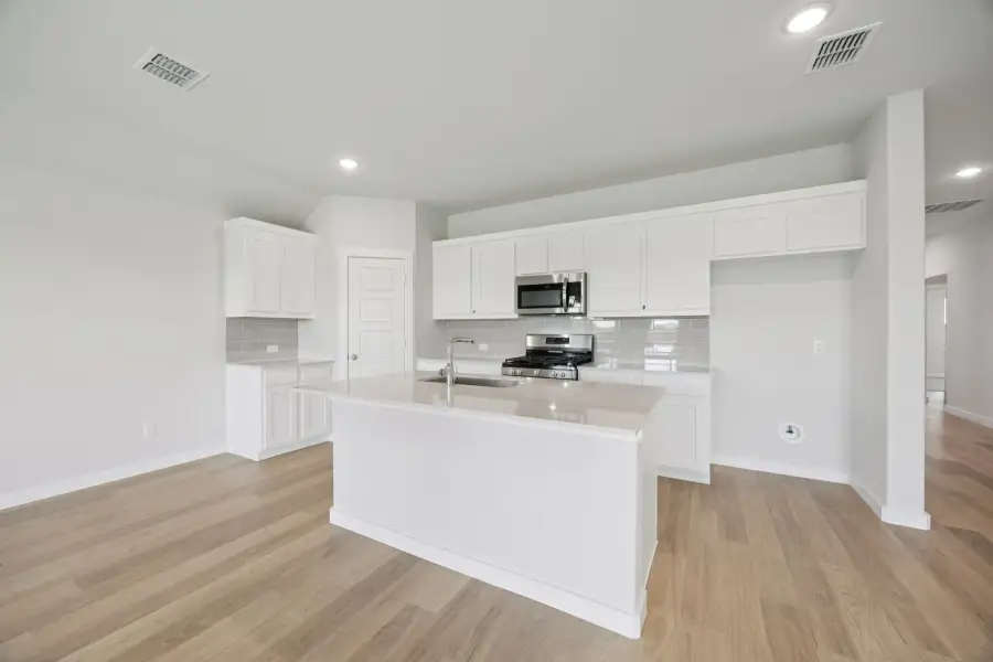 Kitchen in the Hadley home plan by Trophy Signature Homes – REPRESENTATIVE PHOTO