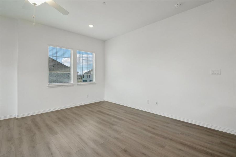 Spare room featuring light hardwood / wood-style floors and ceiling fan