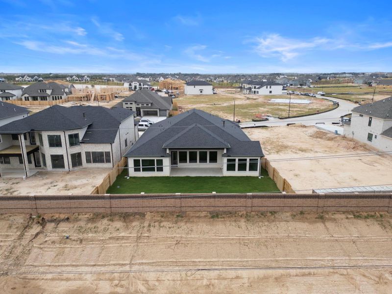 A substantial brick wall backs the homesite, separating it from the coming landscape reserve