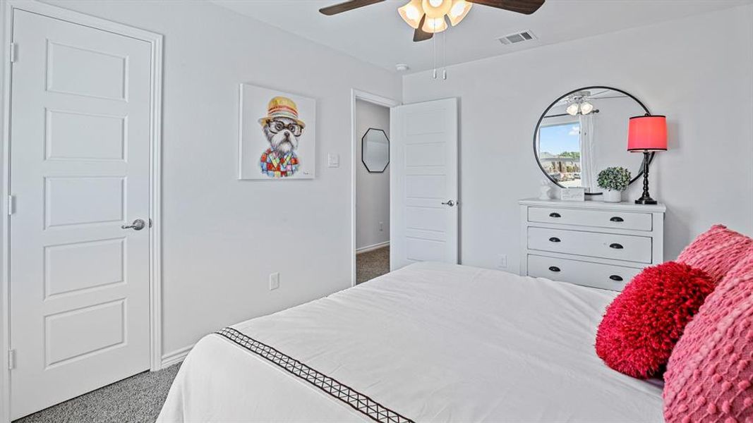 Bedroom featuring light carpet and ceiling fan