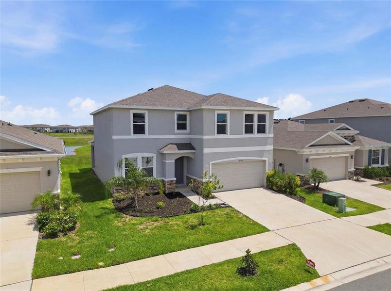 Front exterior of a new home in Epperson, Wesley Chapel, FL, highlighting curb appeal (Image 26). Front exterior of a new home in Epperson, Wesley Chapel, FL, highlighting curb appeal (Image 26).