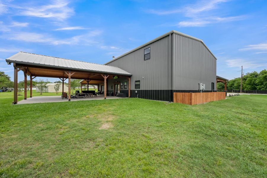 modern, metal-sided building with a spacious covered patio, ideal for outdoor entertainment.