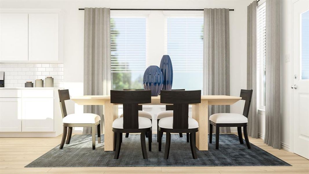 Dining area with a wealth of natural light and light wood-type flooring