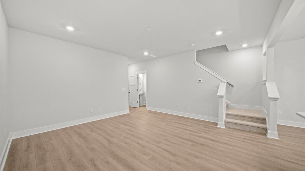 Hardwood flooring and high standards define this vibrant family room ideal for everyday living