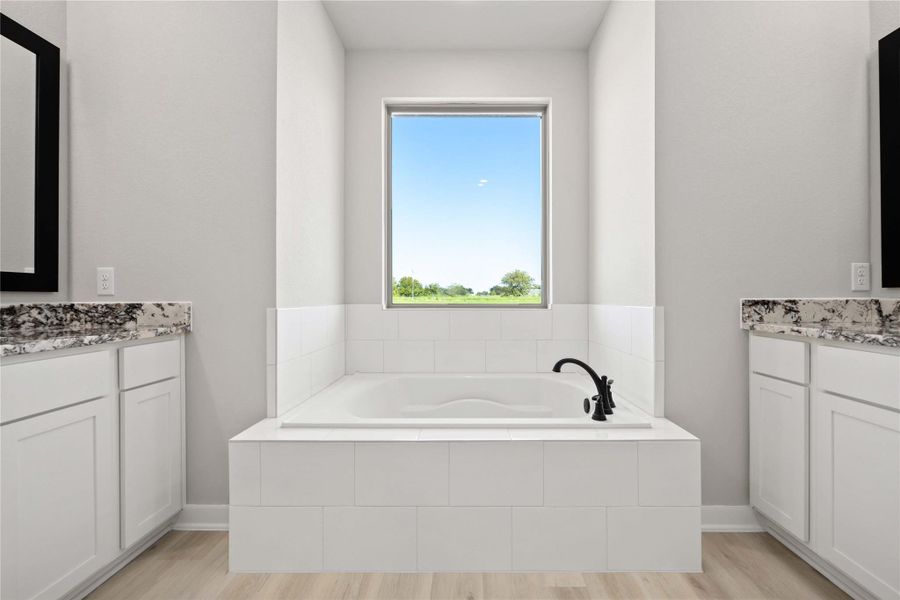 The luxurious owner's retreat is a private oasis with a spa-inspired bath and an extended walk-in closet.