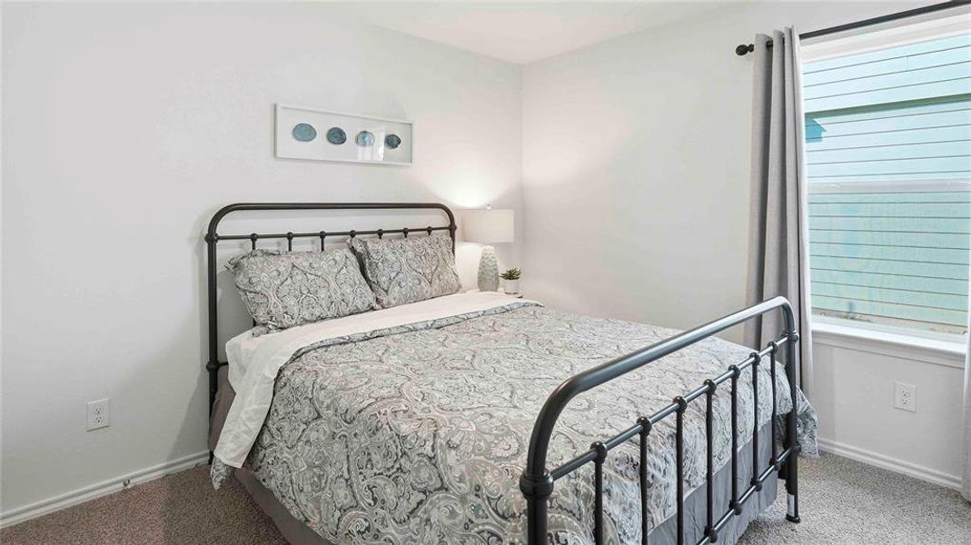 Carpeted bedroom featuring baseboards