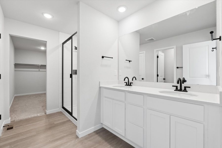 A bathroom with white cabinets. A bathroom with white cabinets.