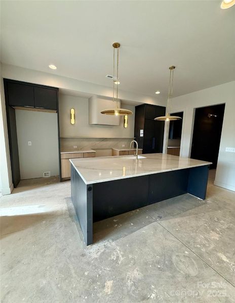 Kitchen view - Panel ready 42" JennAir refrigerator and 36" JennAir Rise range to be installed