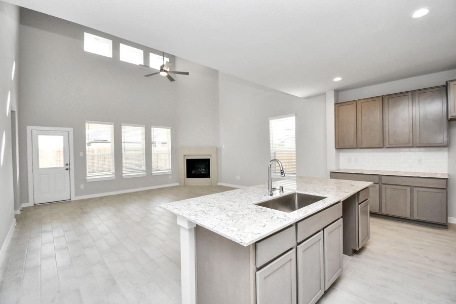 All this opens up to the expansive family room, creating a perfect hub forgatherings. Sample photo of completed home with similar floor plan. Actual colors and selections may vary.