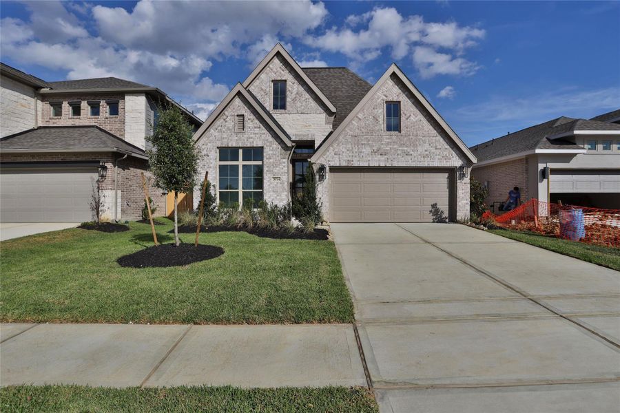 Front exterior of a new home in Amira 45', Tomball, TX, highlighting curb appeal (Image 1). Front exterior of a new home in Amira 45', Tomball, TX, highlighting curb appeal (Image 1).