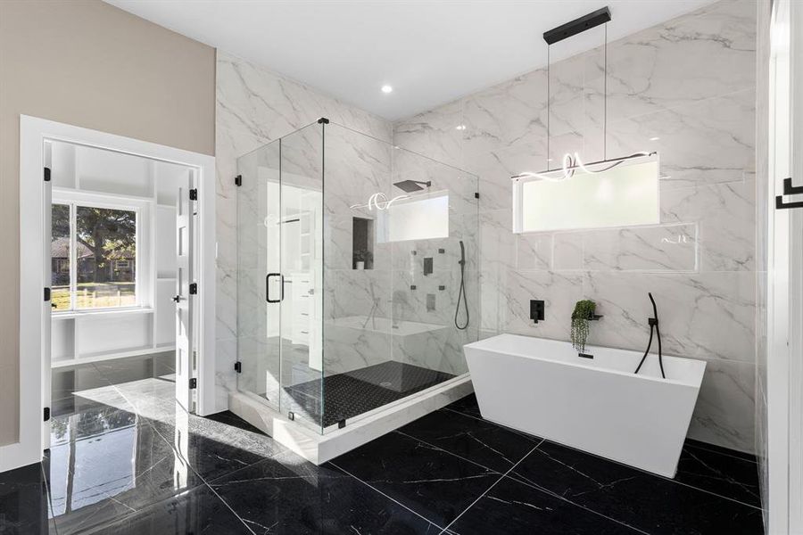 Bathroom featuring shower with separate bathtub