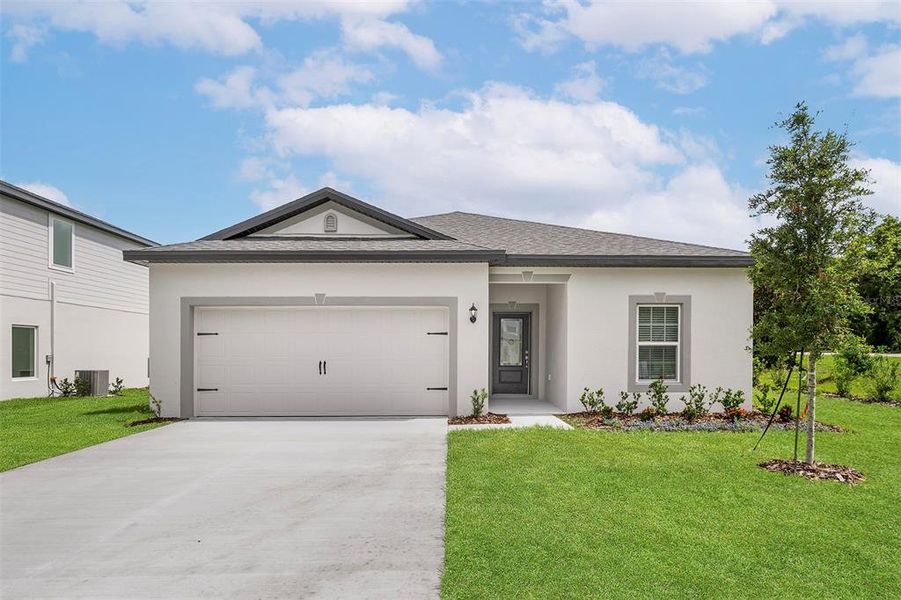 Front exterior of a new home in Tula Parc, Astatula, FL, highlighting curb appeal (Image 2).