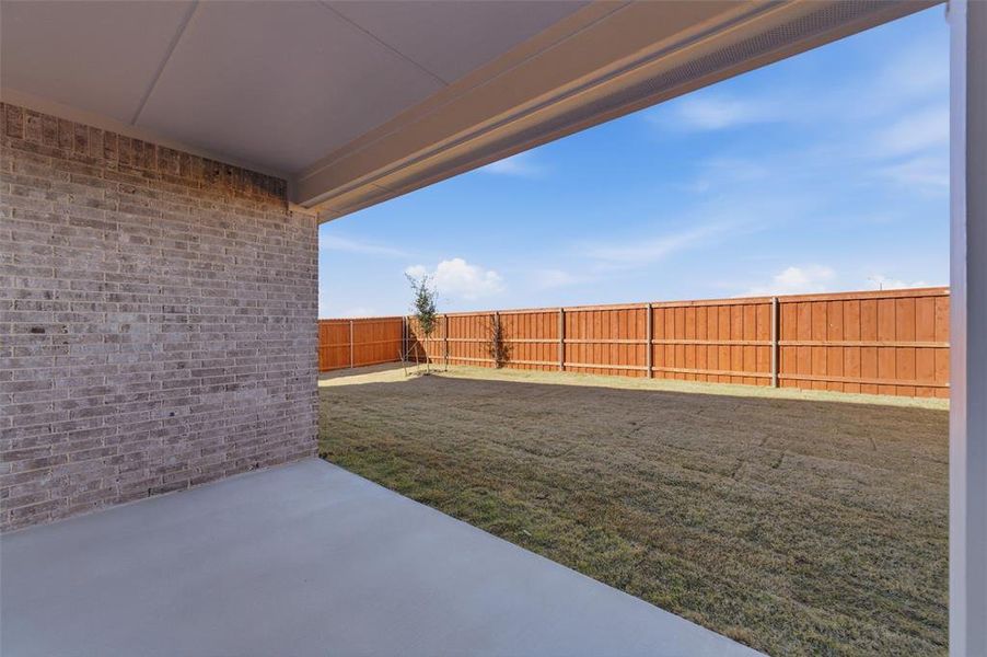 Fenced backyard with a patio area