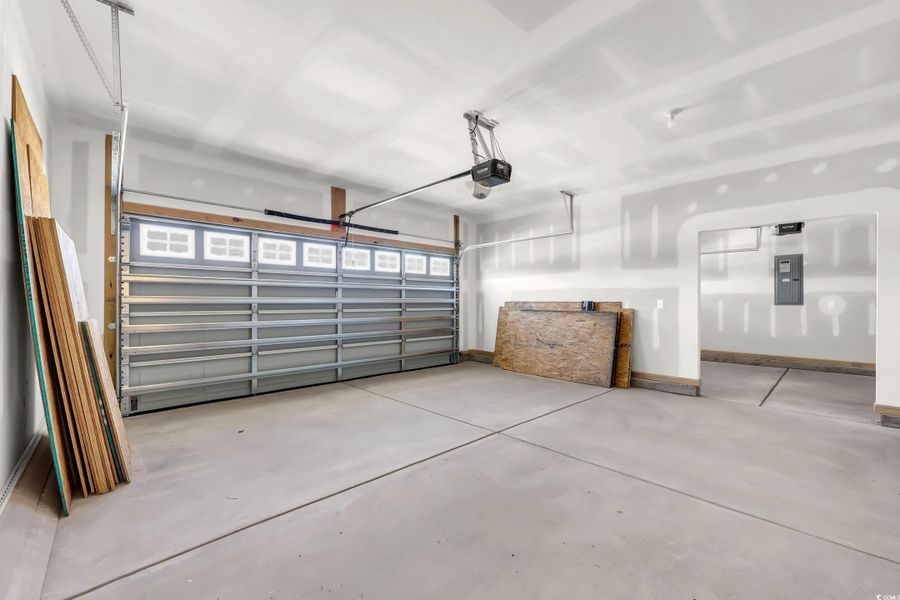 Garage with electric panel and a garage door opener