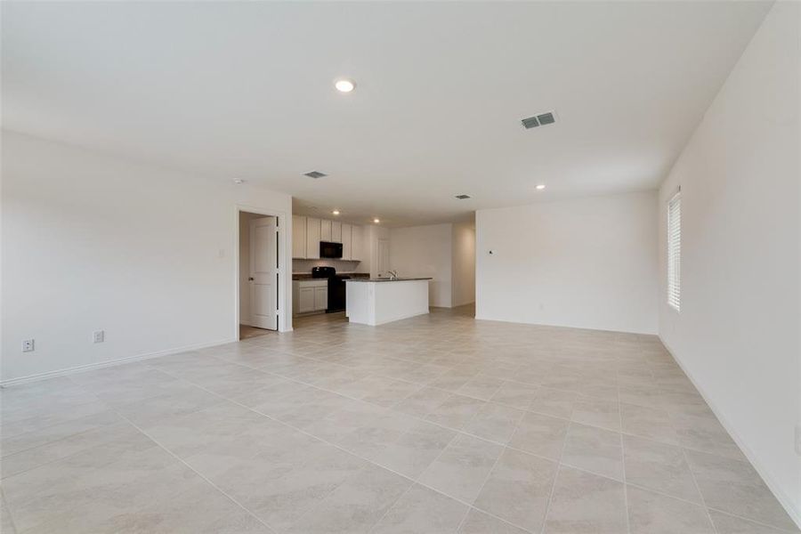 Unfurnished living room featuring light tile patterned floors