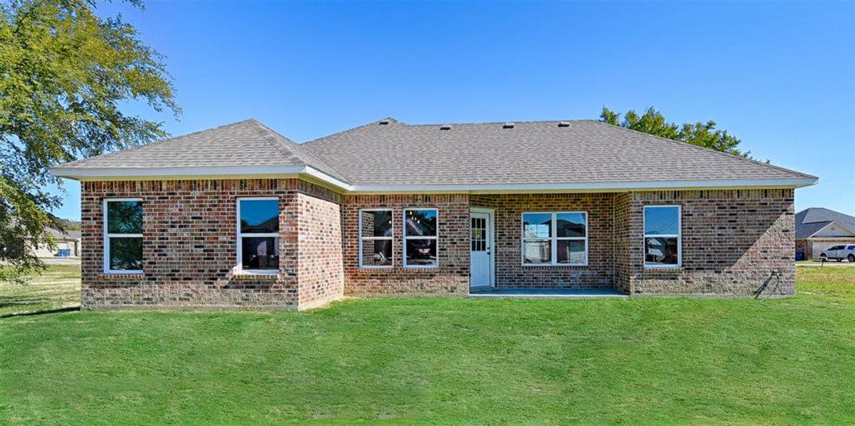 Example of a rear of home for Plan 1501. Full sprinkler and fence included.