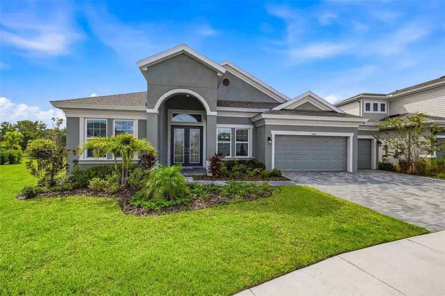 Front exterior of a new home in Waterset, Apollo Beach, FL, highlighting curb appeal (Image 1). Front exterior of a new home in Waterset, Apollo Beach, FL, highlighting curb appeal (Image 1).