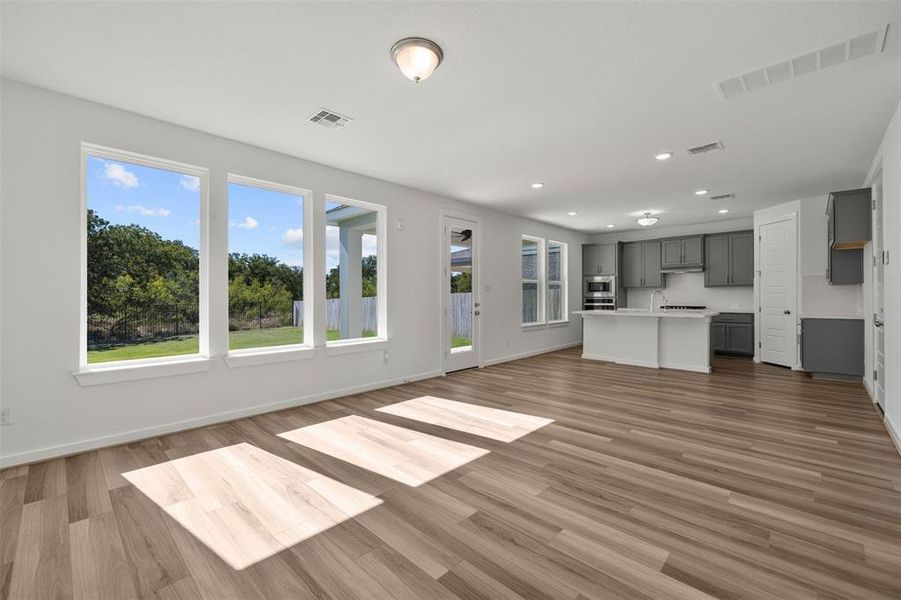 Unfurnished living room with dark wood-style floors and recessed lighting Unfurnished living room with dark wood-style floors and recessed lighting