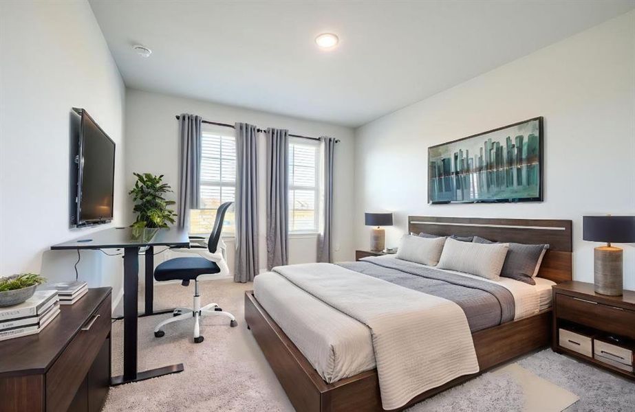 Bedroom with light carpet and an office area Bedroom with light carpet and an office area