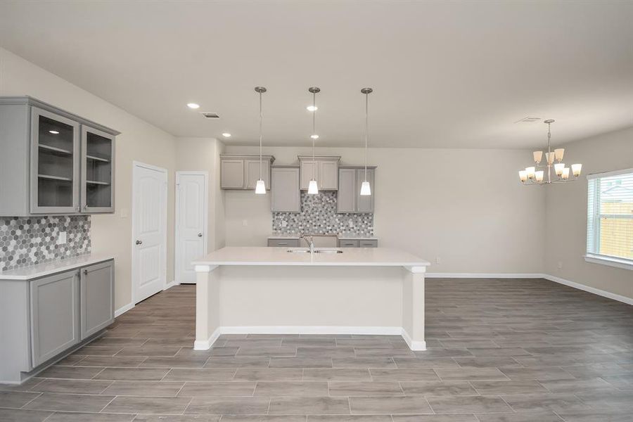 This spacious gourmet kitchen is a chef's dream, with a large center island that provides ample prep space and storage. *This image is from another Saratoga Home with similar floor plan and finishes, not the Brittany floorplan.*