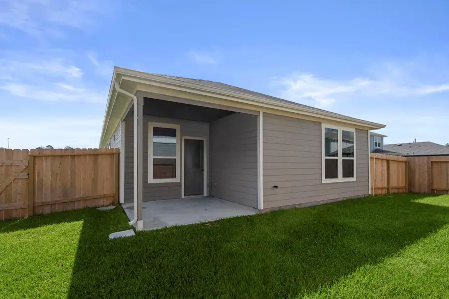 Front exterior of a new home in Peppervine, Porter, TX, highlighting curb appeal (Image 1).