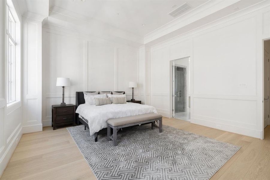 The level of superior craftsmanship is clear in this bedroom, from the custom wainscoting to the high ceilings and thoughtfully placed windows, creating a space that feels both expansive and intimate. (photo of interior model home with smaller floor plan)