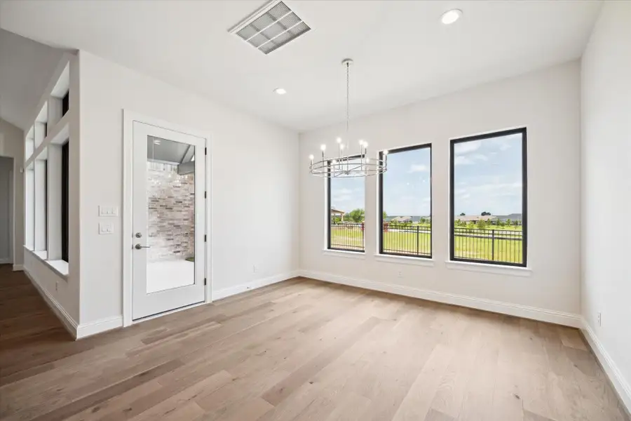 Dining Area off of the Kitchen, with access to the Back Porch and Backyard.